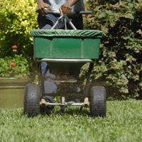 Technician Spreading Fertilizer